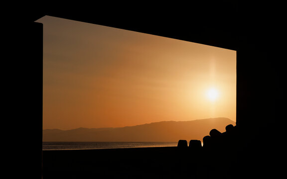 Twilight Window: A Golden Coastal Sunset Moment.