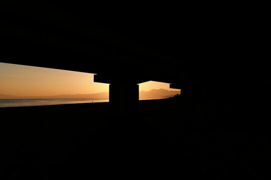 Twilight Window: Golden Coast in the Shadow of the Overpass.
