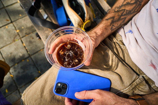 Anonymous man holds a cup of takeaway dring in NYC