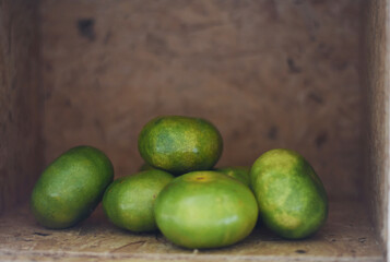 Several mandarins placed in a wooden crate, creating a rustic, fresh, and vibrant still-life scene full of natural color and cozy charm.
