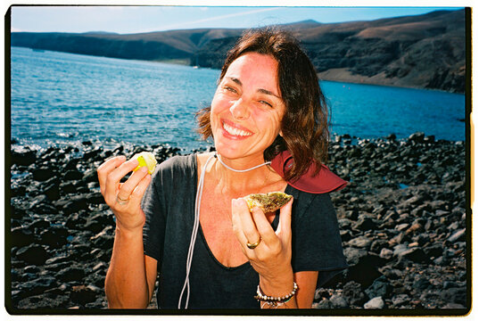 Smiled Woman Eating Oyster Outdoors
