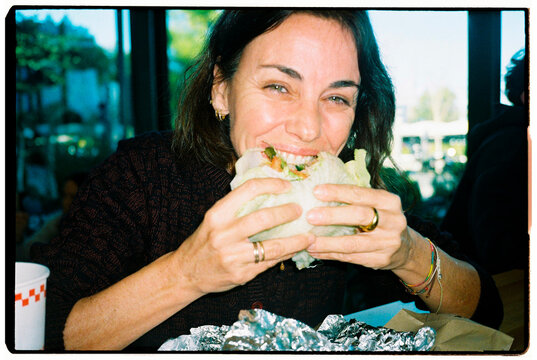 Woman Eating Lettuce Burger 
