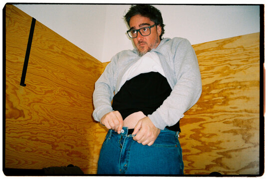 Man Zipping Up Pants