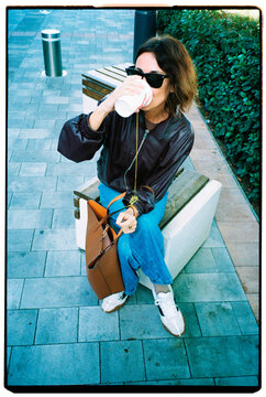 Woman Spilling Drink Outdoors