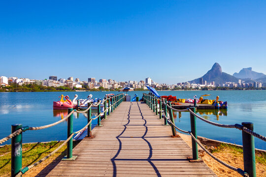 Wooden pier with swan pedal boats at Lagoa Rodrigo de Freitas with Dois Irm&atilde;os mountain in the background, Rio de Janeiro, Brazil.