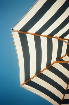 Striped Sun Umbrella Against Blue Sky