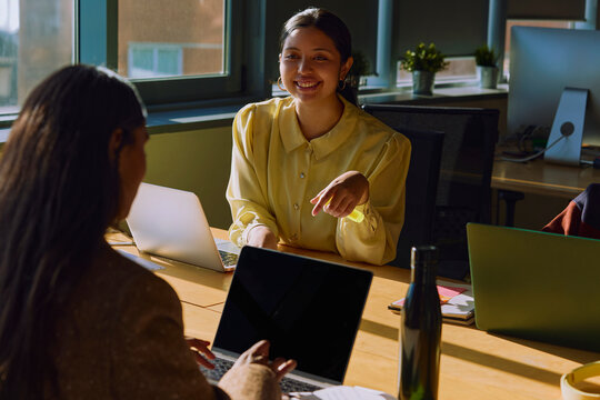 Woman Leading Discussion During Small Team Meeting
