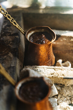 Traditional Turkish coffee brewing in copper pots