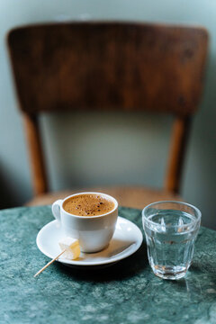 Turkish coffee with water and sugar cube