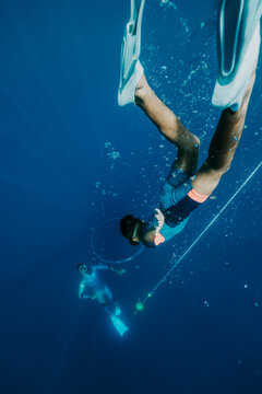 young freediver descending into a bubble ring