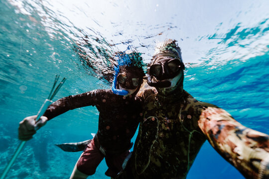 father and son freediving together while spearfishing