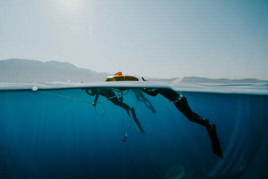freediver at training buoy in open water