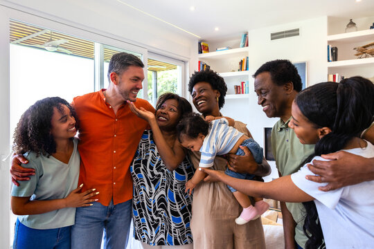 Family gathering with diverse group smiling indoors