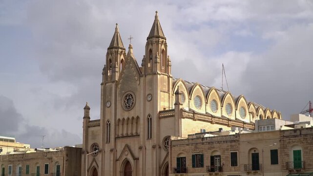 Captivating view of the Balluta Parish Church also known as the Carmelite Church, an example of neo-gothic architecture in Balluta Bay,  Saint Julian's, Malta.