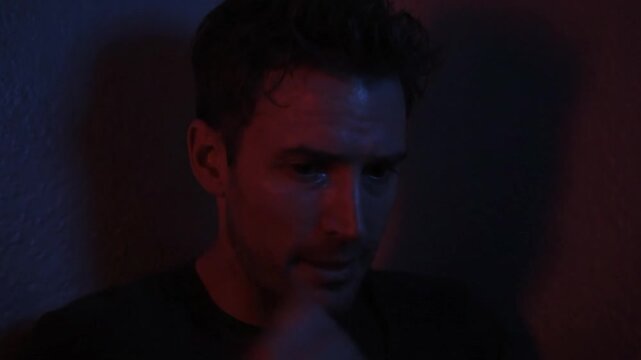 Entering a Quiet Room Under Blue and Red Lighting