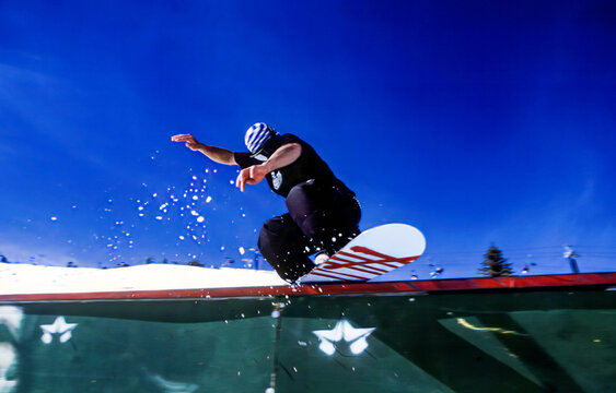 Snowboarder performing a rail slide at Park City, Utah, USA. Captured on slide film with classic analog texture and vibrant tones.
