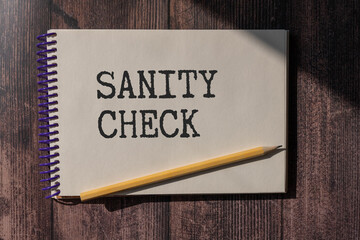the word sanity CHECK is written on a wooden cubes structure . Can be used for Medical concept