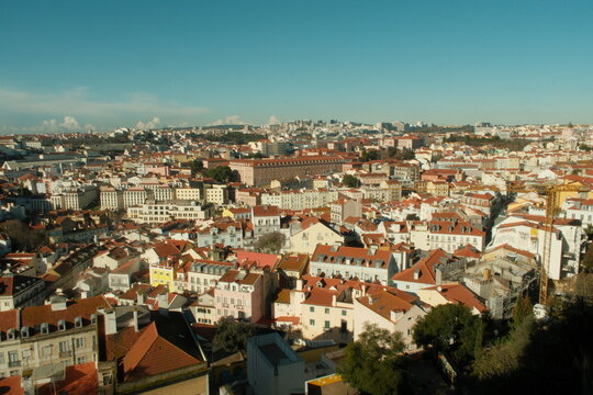 Beautiful red roof tops of portuguese buildings in lisbon on a sunny day with blue sky