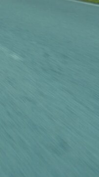 Calm road with streaks and distant grass, Motionfilled shot of quiet road with tire streaks and blurry background