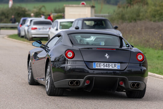 Nancy, France - September 28th 2025 : View on a black Ferrari 599 GTB Fiorano driving on a street.