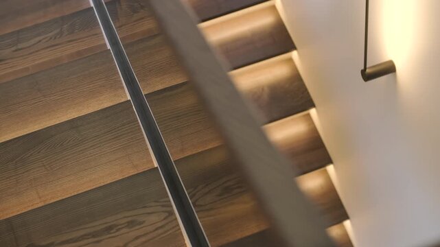 Modern interior design of a wooden staircase with integrated warm LED strip