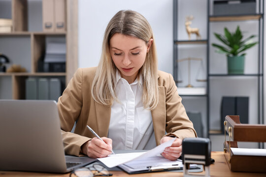 Notary working at wooden desk in office