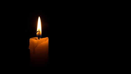 Glowing Candle Illuminating Globe in Dark Room
