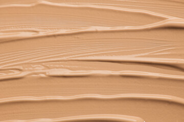 Foundation, concealer, face makeup smudge background, samples, beige smears backdrop. Cosmetic...