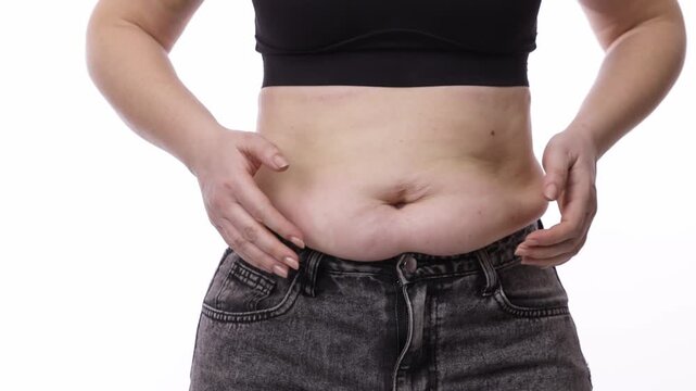 Overweight woman showing noticeable weight gain. Sports, weight loss, and healthy lifestyle concept.
