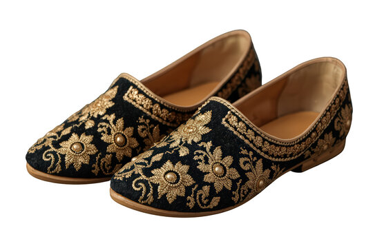 Indian jutti shoes displaying exquisite gold thread work on black velvet fabric, flat traditional footwear with a transparent background