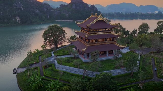 Bai Dinh Pagoda, a spiritual destination, stands majestically on a tranquil lake in Gia Vien, Ninh Binh, Vietnam. The pagoda's architecture reflects Vietnamese culture.