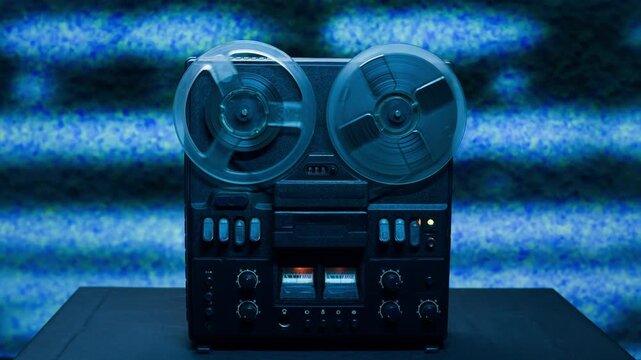 Tape audio music player, VHS studio magnetic tape, vintage retro spool reel to reel player and recorder, magnetic tape data storage close up, music studio. 