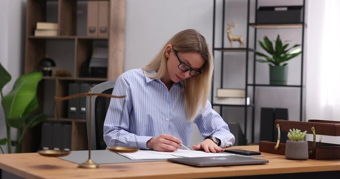 Notary working at wooden desk in office