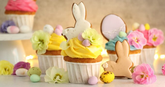 Woman putting tasty decorated Easter cupcake onto table, closeup