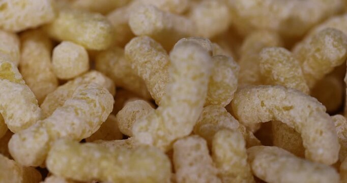 yellow large sticks of corn flour with added sugar for quick cooking with milk or yogurt, ready-to-eat corn sticks scattered on food paper