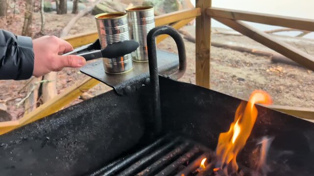 Lighting a fire and cooking canned goulash soup and pouring it up in bowls with cheese bread in early spring. shot in
60fps. this video is 23,976 slowmotion so you can decide how you want it