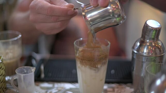 Coffee Art Capture. Closeup Of Coffee Being Poured Into Cream Creating Artful Patterns. An Intricate Shot Showing Thick Coffee Blending Into Milk With Crema Forming Beautiful Layers
