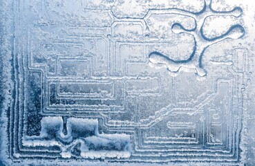 An icy pattern on a window that, instead of abstract lines, forms detailed machine drawings or microchip schematics. Man-made frost. K. Surrealism.