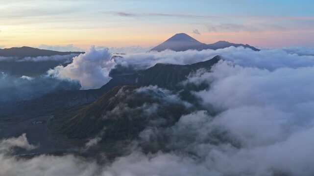 Magnificent aerial view of mount bromo volcano erupting smoke at sunrise. Scenic landscape of the tengger caldera in indonesia at dawn