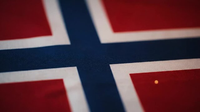 Close-up view of the Norwegian flag waving in the wind, symbolizing national pride and cultural heritage.