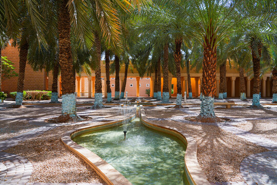 Traditional water fountain and palm grove at the historic Murabba Palace of Riyadh, Saudi Arabia