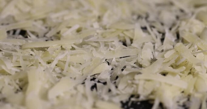 hard ripe cheese grated into small pieces for cooking pizza, grated piece of yellow quality cheese as an ingredient for a large dish