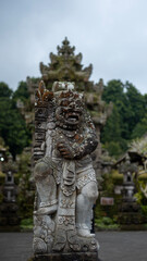 Fototapeta premium Stone Guardian Statue at Balinese Temple