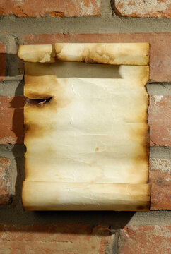 Old scroll of parchment paper letter on a brick wall background