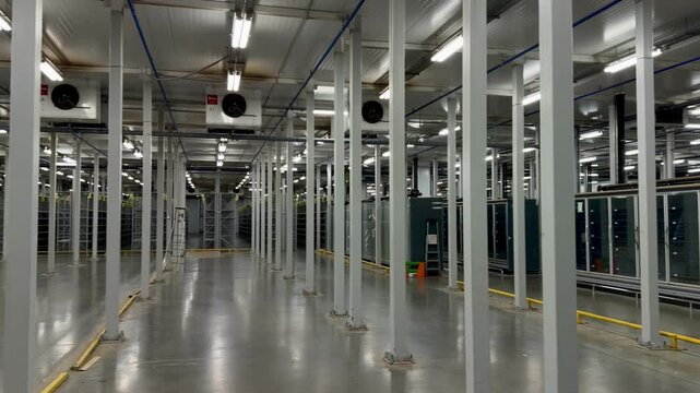 Rows of professional industrial refrigerators and display cases in a warehouse. High-tech cold storage facility for food logistics, retail supply chain and temperature-controlled environment.