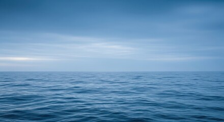 Fototapeta premium Calm ocean water under a cloudy blue sky creating serene natural landscape