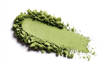 A vibrant green powder is artfully scattered on a white background, showcasing its texture and color depth.