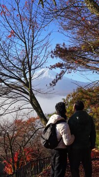 LGBTQ couple Intimate travel moment with Fuji mountain and fall colors