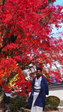 Man in kimono enjoying autumn season in Kyoto garden