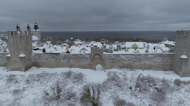 Aerial Approach to Visby City Wall With Symmetrical Towers and Snow Covered Old Town, Gotland
